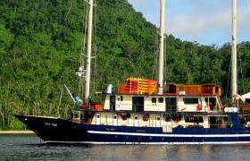 The Tui Tai ship is docked in a scenic, secluded bay